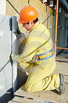 Facade Plasterer at exterior insulation work photo