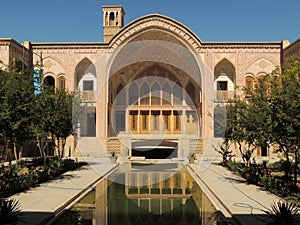 Facade, pool and wind tower of Kashan traditional palace