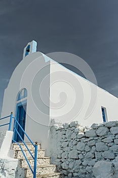 Facade with porch of traditional white blue Greek