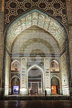 Facade portal of Ulugbek Madrasah from Registan Square with night lighting. Samarkand