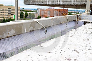 facade protective mesh stretched over a steel frame for fencing scaffolding