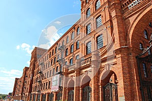 Lodz - Poland. 17 August 2019: Facade of red brick factory building. Old factory in Lodz