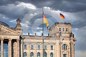 Facade Reichstag building Berlin with german flag and threatening air