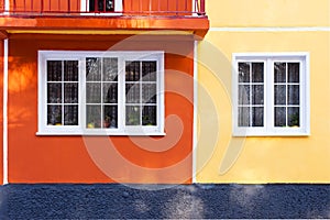 Facade of a residential building, a window with a white frame and red-brick walls, minimalism, linearity and clean design