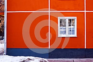 Facade of a residential building, a window with a white frame and red-brick walls, minimalism, linearity and clean design.