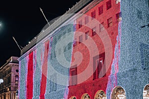 Facade of Rinascente department store on Corso Vittorio Emanuele ii near Duomo in Milan, Italy. The shop is lit up with photo