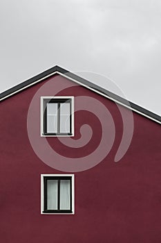 Facade and roof of a dark red house