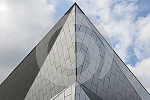 Facade and roof of a modern metal building. Geometric lines and patterns are abstract architectural background