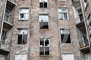 Old red brick house with broken windows, former Jewish ghetto in Warsaw photo