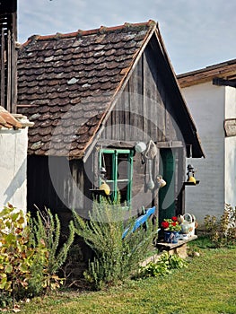 Facade of a rural house decorated with flowers and other old decorations