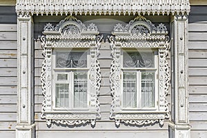 Facade of a Russian wooden house with platbands