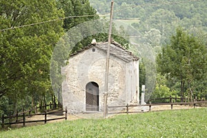 Facade of a small chapel among the trees in Piedmont, northern Italy
