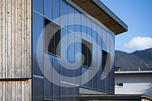 Facade of a sustainable wooden prefabricated house with solar thermal collectors for heating photo