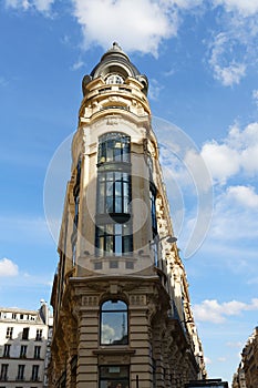 The facade of traditional French house with typical balconies and windows. Paris.