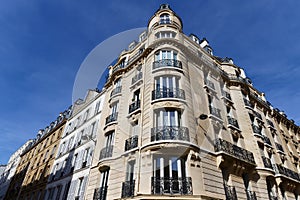 The facade of traditional French house with typical balconies and windows. Paris