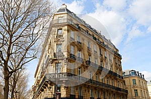 The facade of traditional French house with typical balconies and windows. Paris.