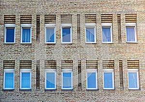 Facade of the two-storey white brick building