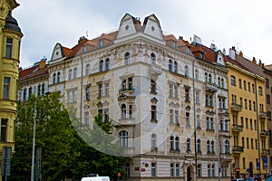 Facade of a typical colorful classic building in a street in middle of Prague, Czech Republic