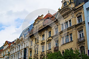 Facade of typical colorful classic buildings in a street in middle of Prague, Czech Republic