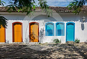 Facade of typical colorful house with cobbled street in Paraty, Rio de Janeiro, Brazil