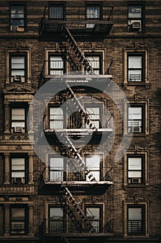 Facade of a typical New York block of flats with fire escape at