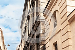 Facade of a typical old French residential building in Bordeaux, France, made of freestone, hosting flats