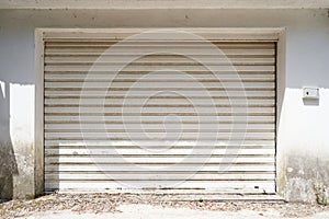 Facade of an uncleaned garage with gray gates