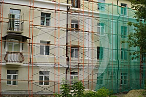 Facade under construction with scaffolding and protective net