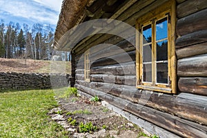 Facade of a very old wooden house with window