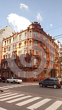 Facade view of a neoclassical brick building, in Republica Arabe and Cabello streets. Buenos Aires, Argentina