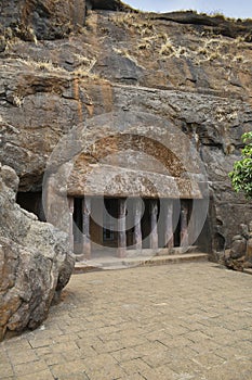 Facade of a Vihara near Cave No. 20 showing Cell Doors with rock-cut at Bhaja Caves, Ancient Buddhist built in 2nd century BC,