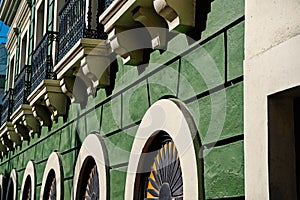 Facade wall on green plastered background in San Juan, Puerto Rico
