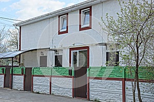 Facade of a white concrete private house with windows