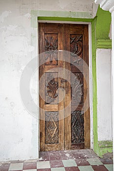 Facade of a white and green traditional house