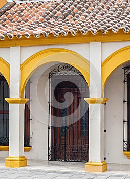Facade of a white and yellow traditional house. Tlacotalpan, Veracruz, Mexico