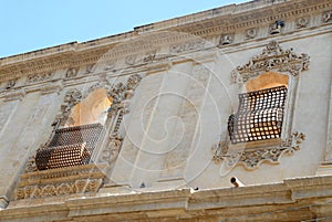 Facade with window and door of an elegant building in Noto in Sicily (Italy)