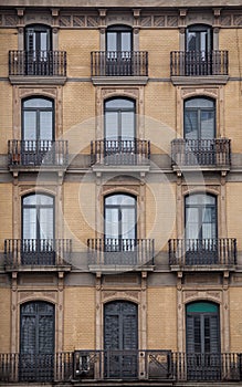 Facade with windows and balconies, historic building. Barcelona city. Spain