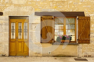 Facade wood shutters and flowers Cajarc