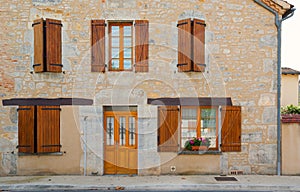 Facade wood shutters and flowers Cajarc France