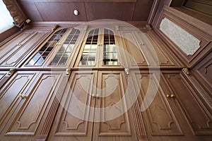 Facade of a wooden bookcase with glass inserts, photo