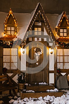 The facade of a wooden house, decorated for Christmas or new Year