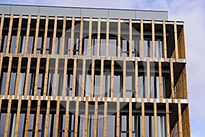 Facade of wooden modern building clad in ecological wood concept of sustainable construction