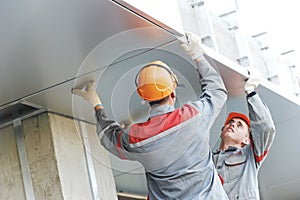 Facade workers installing metal boarding