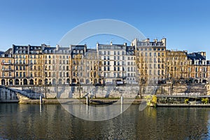 Facades of apartment buildings at Ile de la cite with nice blue sky in Paris