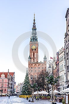 Facades of colorful historical merchant houses and the tower of the city hall in the center of Gdansk, Poland