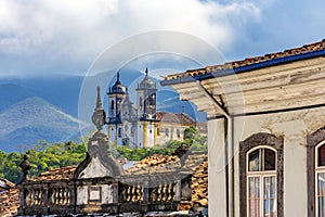 Facades of historic houses and churches with the mountains