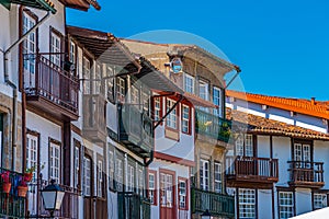 Facades of houses at Praca de Sao Tiago in the old town of Guimaraes, Portugal