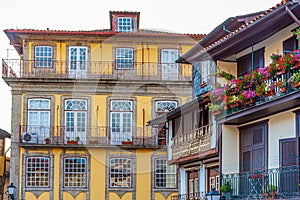 Facades of houses at Praca de Sao Tiago in the old town of Guimaraes, Portugal