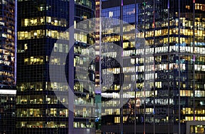 Facades of modern office buildings with glass walls  at night