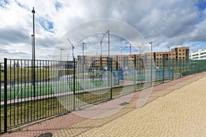 Facades of new buildings in an urbanization with common areas with sports fields